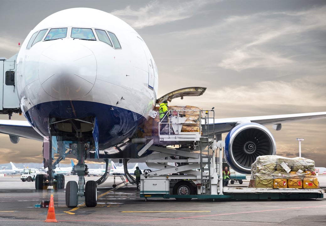 Loading Cargo into the Airplane before Departure with Nice Sky